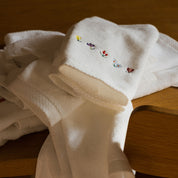 Serviettes de bain Luxus blanches, en coton, avec des fleurs brodées
